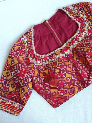 Flowy Malai silk saree in grey paired with a red Patola blouse