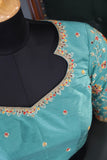 A classic patola in aqua blue with a striking contrast red