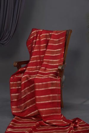 A striking red Mashru silk saree with a designer blouse