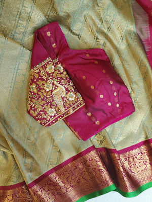 A Royal Gadwal kanchi saree in sage green with rich magenta border
