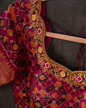 Brown kanjeevaram saree with a contrast dark pink border and Patola blouse