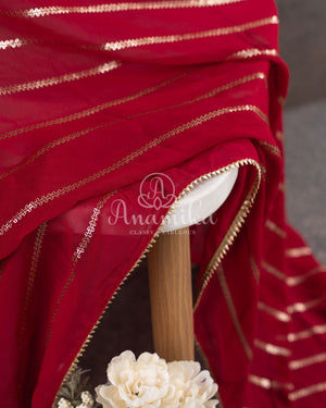 Red Georgette saree with a contrast peach floral blouse