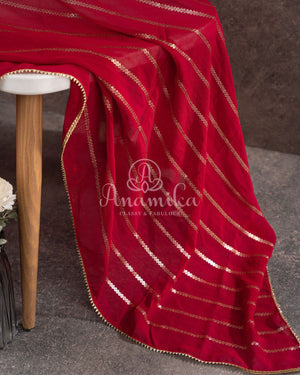 Red Georgette saree with a contrast peach floral blouse