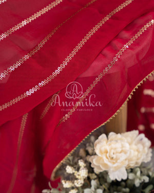 Red Georgette saree with a contrast peach floral blouse