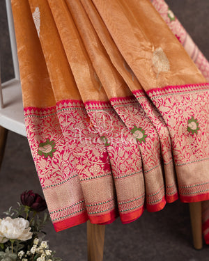 Sandstone Orange Kora Banarasi Tissue saree with a contrast pink blouse