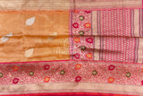 Sandstone Orange Kora Banarasi Tissue saree with a contrast pink blouse
