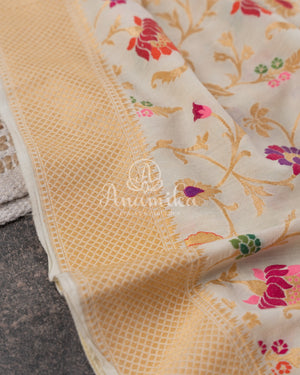 Cream Pure Munga Tusser saree with all over floral meenakari work, paired with a contrast purple blouse