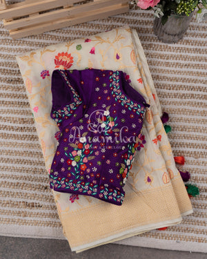 Cream Pure Munga Tusser saree with all over floral meenakari work, paired with a contrast purple blouse