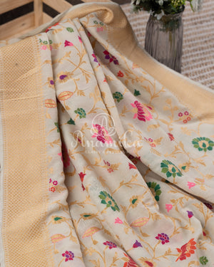 Cream Pure Munga Tusser saree with all over floral meenakari work, paired with a contrast purple blouse