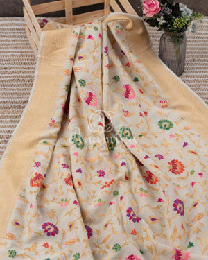 Cream Pure Munga Tusser saree with all over floral meenakari work, paired with a contrast purple blouse