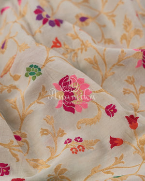 Cream Pure Munga Tusser saree with all over floral meenakari work, paired with a contrast purple blouse