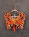 Black Floral georgette saree with a contrast orange 3D flower work blouse