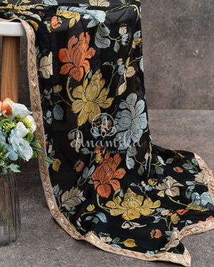 Black Floral georgette saree with a contrast orange 3D flower work blouse