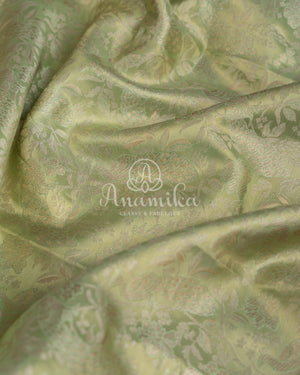 Kanjeevaram saree in pastel green shade paired with a contrast pink blouse