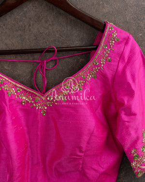 Kanjeevaram saree in pastel green shade paired with a contrast pink blouse