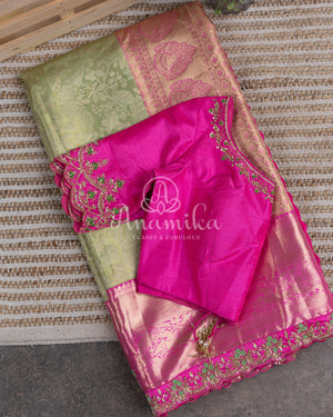 Kanjeevaram saree in pastel green shade paired with a contrast pink blouse