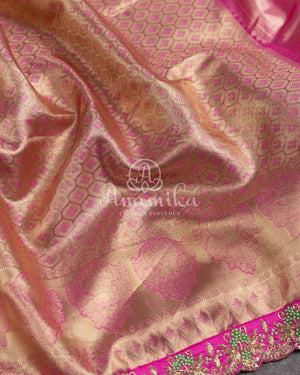 Kanjeevaram saree in pastel green shade paired with a contrast pink blouse