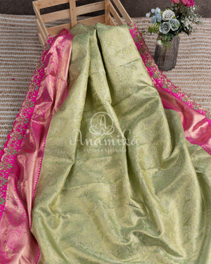 Kanjeevaram saree in pastel green shade paired with a contrast pink blouse
