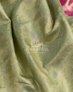 Kanjeevaram saree in pastel green shade paired with a contrast pink blouse
