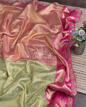 Kanjeevaram saree in pastel green shade paired with a contrast pink blouse