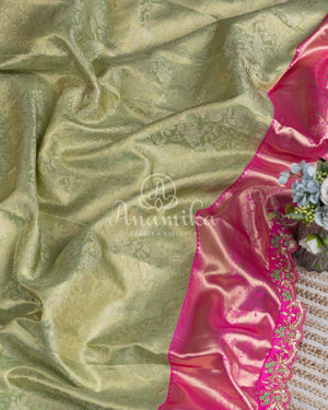 Kanjeevaram saree in pastel green shade paired with a contrast pink blouse