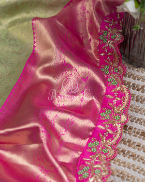 Kanjeevaram saree in pastel green shade paired with a contrast pink blouse