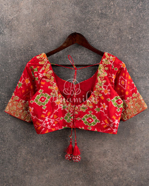 Pure Bandini Silk saree in bottle green with a contrast red patola border