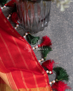 Pure Bandini Silk saree in bottle green with a contrast red patola border
