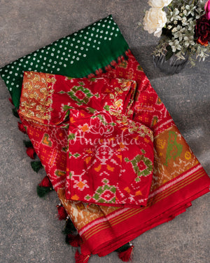 Pure Bandini Silk saree in bottle green with a contrast red patola border