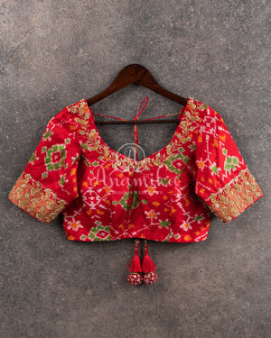 Pure Bandini Silk saree in bottle green with a contrast red patola border