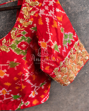 Pure Bandini Silk saree in bottle green with a contrast red patola border