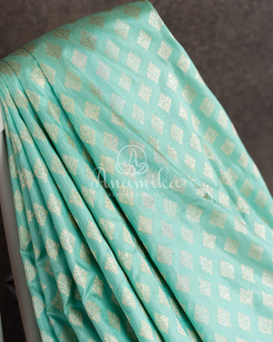 Teal Banarasi Silk Saree with a contrast hand work blouse