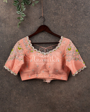 Pastel peach Pink Gadwal saree with a contrast pastel green border and blouse