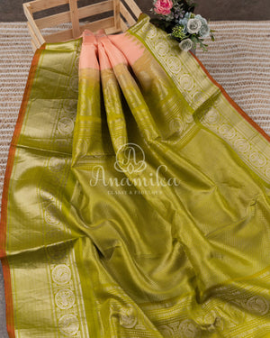 Pastel peach Pink Gadwal saree with a contrast pastel green border and blouse