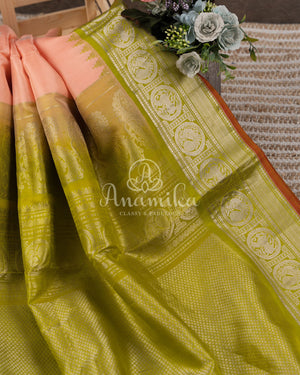 Pastel peach Pink Gadwal saree with a contrast pastel green border and blouse