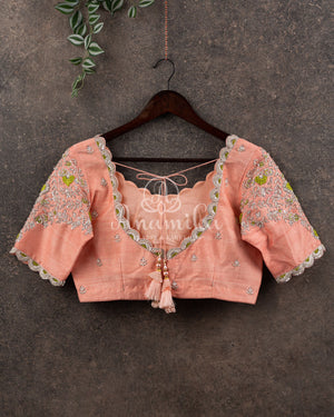 Pastel peach Pink Gadwal saree with a contrast pastel green border and blouse