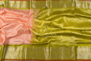 Pastel peach Pink Gadwal saree with a contrast pastel green border and blouse