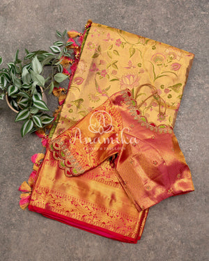 Bridal Kanjeevaram tissue saree in gold, with a contrast pink border