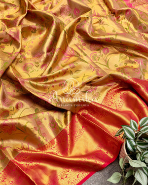 Bridal Kanjeevaram tissue saree in gold, with a contrast pink border
