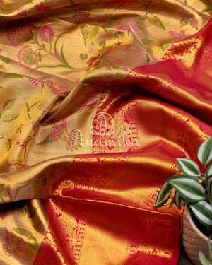 Bridal Kanjeevaram tissue saree in gold, with a contrast pink border