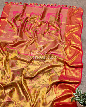 Bridal Kanjeevaram tissue saree in gold, with a contrast pink border