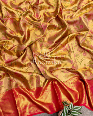 Bridal Kanjeevaram tissue saree in gold, with a contrast pink border