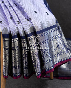 Lavender Gadwal Pattu saree with a contrast dark blue border and pallu
