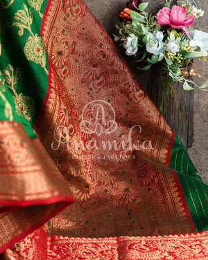 Dark Green Chanderi Silk saree with all over jaal weaving and a contrast red border