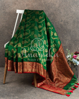 Dark Green Chanderi Silk saree with all over jaal weaving and a contrast red border