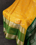 A traditional venkatagiri pattu saree in festive colors of yellow and green