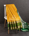 A traditional venkatagiri pattu saree in festive colors of yellow and green