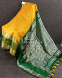 A traditional venkatagiri pattu saree in festive colors of yellow and green