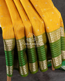 A traditional venkatagiri pattu saree in festive colors of yellow and green