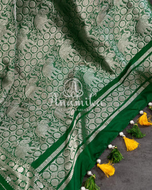 A traditional venkatagiri pattu saree in festive colors of yellow and green